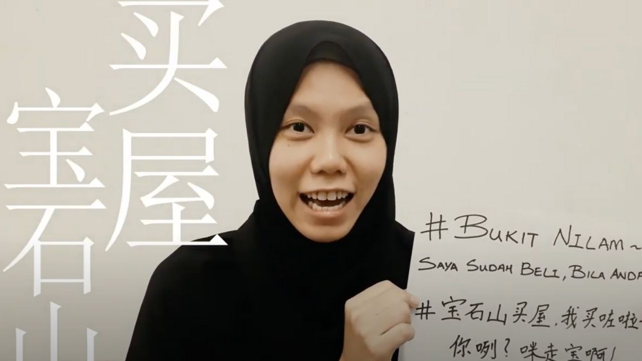 a malay young lady holding paper and announcing that she bought a house